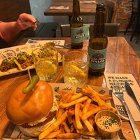 The Mad Nashville (12,95€) with spicy cajún fries. Loved the sauce and the tiny pickle, but the bun was boring. at Mad Mad Vegan - Chueca in Madrid