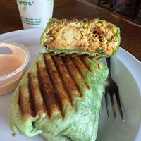 Vegan Treehugger Wrap- Tofu scramble, tots, spinach, sautéed peppers and onions, vegan breakfast sausage, vegan cheese, and tomatoes at Drunken Monkey Coffee Bar in Orlando