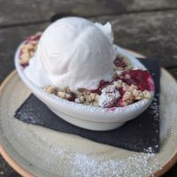 Apple and blueberry crumble with coconut ice-cream at The Old Lodge in Stroud