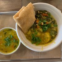 Bowl with two veggies, cup of sambhar at Nourish Wellness Cafe in Costa Mesa