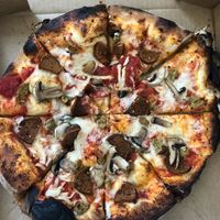 Pizza with vegan cheese, vegan sausage, and vegan pepperoni  at The Parlor in Austin