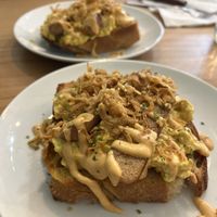 Scrambled tofu on toast, Swedish sausage, harrisa mayo and crispy onions   at Dauns in East London