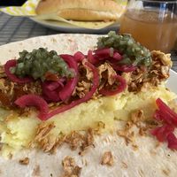 Vegan seitan sausage, mash, ketchup, mustard, picked onions, cucumber relish and crispy onions  at Dauns in East London