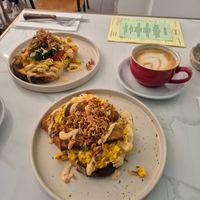 Scramble Tofu, served on Sourdough Toast, Harissa Mayo, Crispy Onion with Tomato & Spinach (left one) and with Seitan Sausage. at Dauns in East London