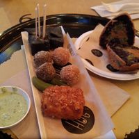 Antipasti misti: tofu fritto, falafel, olive ascolane e bocconcini di mais al carbone. Arancino di riso venere. at HUG at Turnè in Monza