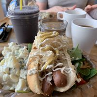 ‘Top Dog’ w. sauerkraut, melted cheese, mayo, senap, potato salad and green salad. ‘Blues & Greens’ smoothie w. added spirulina, chocolate ball.  at Delivore in Stockholm