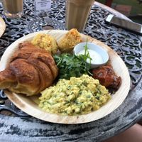 ‘Amelie’ Scrambled tofu, croissant, handmade hash browns, ginger roasted tomatoes, garlic aioli  at Wild Spice Kitchen in Annerley