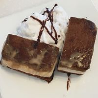 Ginger chai ice cream sandwich (sliced for sharing) with coconut cream at Ananda Fuara in San Francisco