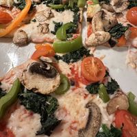 Pizza with vegan cheese, tomatoes, zucchini, mushrooms, spinach, sweet peppers   at Piola in Miami Beach