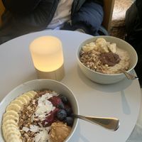 Acai blueberry bowl and oat porridge with toppings  at GRØD in Aarhus