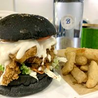 Black magic mushroom burger, comes with slaw on the side and potato wedges   at Blue in Penang