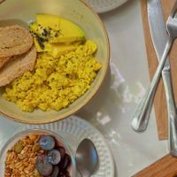 Vegan yogurt, toasts with scrambled tofu and avocado and coffee latte  at Alimentos da Vila in Salvador