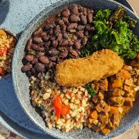 Beans, pea protein, kale and rice with farofa at Banana Verde in Sao Paulo