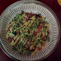 Risoto negro: arroz negro, queijo de castanhas, abóbora assada, champignon, alho-poró, queijo parmesão veg, semente de abóbora e brotos ao pesto de manjericão basílico ($92) at Banana Verde in Sao Paulo