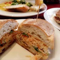 Vegan bahn mi sandwich and vegan macaroni & cheeze with broccoli in the background, and some garlic bread on the side at Herbivore - Mission District in San Francisco