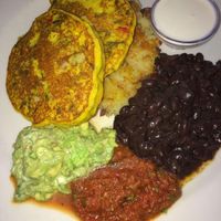 Corn cakes, black beans and hash brown - with guacamole and salsa. It was good. at Herbivore - Mission District in San Francisco