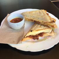 Sausage, sauerkraut and hashbrown jaffle with chutney at For Change Cafe - Melbourne Uni. in Parkville