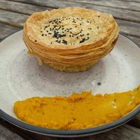 Vegan creamy mushroom pie with pumpkin hummus on the side. at Gratitude in Tauranga