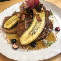 Vegan French toast with coconut bacon, blueberries (fresh and freeze dried) as well as edible flowers  at Gratitude in Tauranga