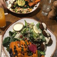 Kale caesar salad with falafel and poke with falafel at Honest Greens - Plaça Catalunya in Barcelona