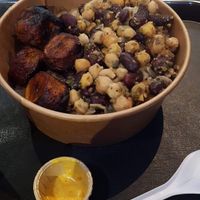 Vegan yassa bowl with (extremely!) hot sauce in the foreground at Osè African Cuisine in Paris