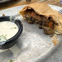 Freaking amazing! Great vibes, good vegan pasties! I have the vegan Guinness Stew pasty & it did not disappoint! Half is already eaten. I love how many vegan options they have.   at Cornish Pasty Co in Flagstaff