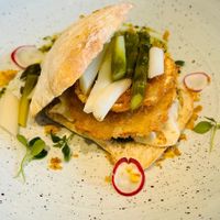 A burger with a celeriac patty and pesto and asparagus and also thinly sliced raw celeriac(marinated)  at Bahnhöfli in Haag