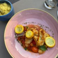 Safran couscous with baked tomatoes and breaded  and baked zucchini   at Bahnhöfli in Haag