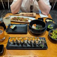 From top to bottom left to right: basil-lime mojito, mai tai, the wedge specialty roll, cucumber maki, point reyes specialty roll, agedashi tofu, garlic edamame at Tane Vegan Izakaya in Honolulu