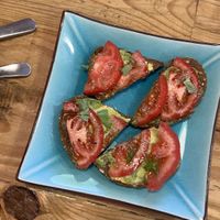 Toast with avocado and tomato and fresh herbs   at Izzy's Market Vegetarian Boutique in Vila Do Bispo