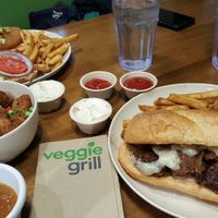 Santa Fe chicken sandwich, Beyond cheesesteak & cauliflower with sweet & sour orange dipping sauce at Veggie Grill by Next Level - River North in Chicago