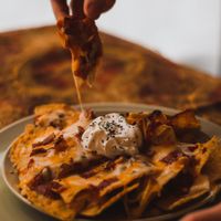 Cheesy nachos goodness - add a serving of vegetarian meat to make it a meal! at Bonthé in Granby