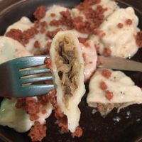 Mushroom and cabbage pierogies topped with vegan bacon  at no bones in Krakow