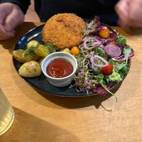Schnitzel with potatoes and salad  at no bones in Krakow