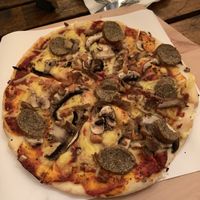 Four mushrooms pizza with added vegan sausage at no bones in Krakow