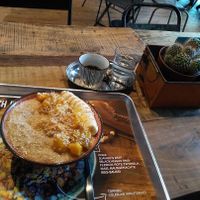 Porridge with mango, banana, coconut and agave syrup as toppings. at Kahuna Poke Bros in Frankfurt