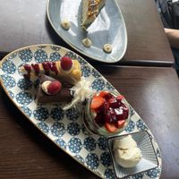 The dessert platter in the front and a piece of snickers cake in the backk  at Kuli Alma in Frankfurt