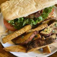 Sándwich Bacco con batatas fritas   at Shipibo Bistro Amazonico in Ramos Mejia