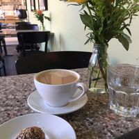 Vegan orange raw ball and coffee with oatmilk at Chokladfabriken in Stockholm