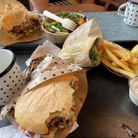 Half eaten cheeseburger, chilli burger and kitchen wrap  at Swing Kitchen - Schwedenplatz in Vienna