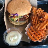 Vegan burger and sweet potato waffle fries at Swing Kitchen - Schwedenplatz in Vienna