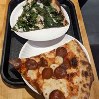 Pepperoni and top slice is a kale, white pizza creation at 20th Street Pizza in Philadelphia