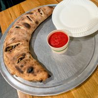Giant calzone with meatball crumbles, peppers, and mushrooms at 20th Street Pizza in Philadelphia