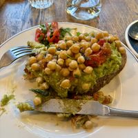 ‘Mortgage on Toast’ - Smashed avo with spinach, tomato and spiced chickpeas - they omitted the mint yogurt and feta - super filling and tasty!  at Box Sociaal in Amsterdam