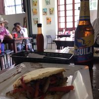 Violeta Parra arepa with Colombian beer at Quero Arepa in Cartagena