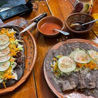 Huarache azteca -guisos chicharrones and papamaica (bottom). Enfrijoladas with asada (top) at La Vegana Garnacha in Guadalajara