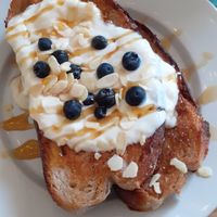 French toast with yoghurt, blueberries, almonds and maple syrup. at Chapter One Coffee Shop in Edinburgh