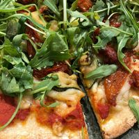 Sourdough pizza with tomate sauce, AMAZING vegan mozzarella, zucchini, dehydrated tomatoes, fresh basil and arugula at Odacova in Barcelona