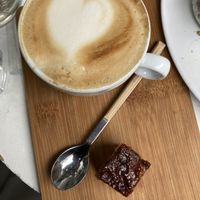 Cappuccino with tasty piece of cinnamon bun   at Plenty in The Hague
