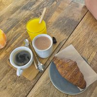 Black coffee, hot chocolate, fresh orange juice and a croissant  at Plenty in The Hague